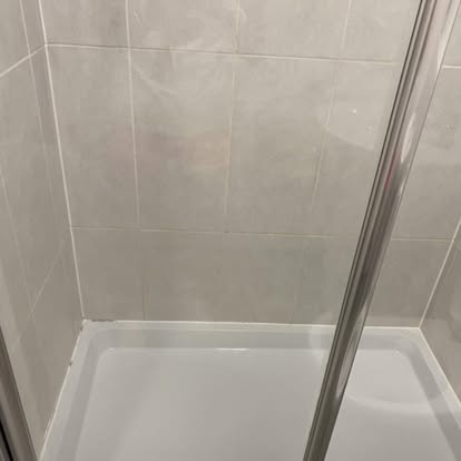 Shower after clean, tiles and tray gleaming